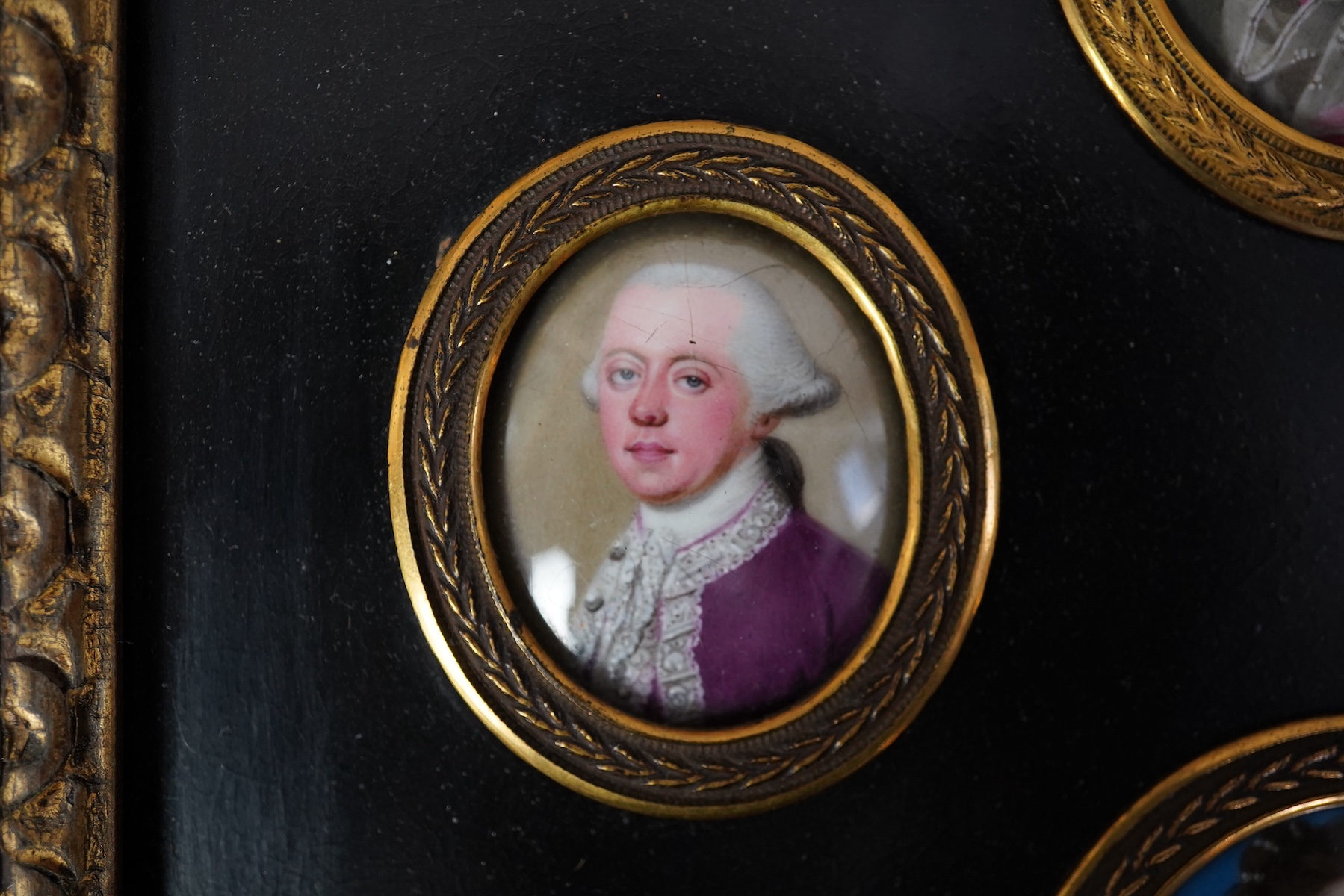 English School c.1760, Miniature portraits of the Cartwright Family, enamel on copper (4), largest 4.5 x 3.75cm, framed as one